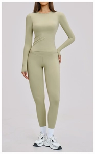Detailed close-up of light green yoga set featuring seamless long sleeve top and leggings