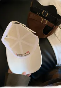 Detail view of retro baseball caps showing wash labels and embroidery on internal cotton lining