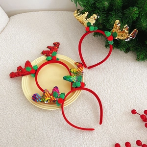 Detailed overhead shot of festive reindeer headbands with sequins and holiday decorations