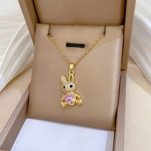 Detail of bunny pendant with pink heart gemstone and zircons on velvet jewelry box