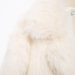 Chic oversized white faux fur coat with lapel collar and soft plush texture