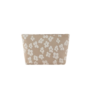 Minimalist beige makeup bag with white 3D floral pattern on textured fabric