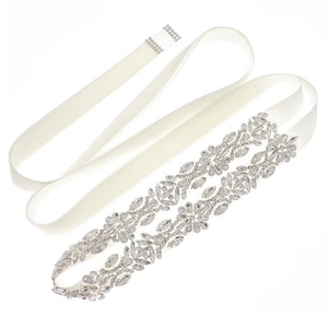 Close-up of elegant bridal sash with sparkling crystal flowers and white satin ribbon