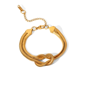 Close-up of golden stainless steel snake chain bracelet with knot design and lobster clasp