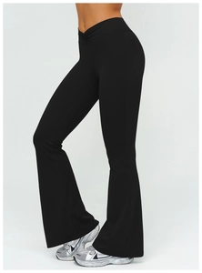 Detail of high-waist flared yoga pants featuring a unique V-cross waistband design in black