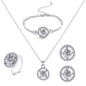 Detail of silver jewelry set with round halo cubic zirconia pendant and earrings