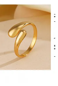 Macro view of gold geometric teardrop ring showing polished finish and open design
