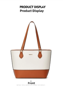 Front view of a two-tone tote bag in cream and caramel brown with gold metal detail