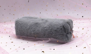Close-up of grey plush pencil case with soft faux fur texture and gold zipper details