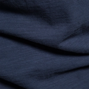 Detailed macro view of dark blue slub cotton fabric texture on summer t-shirt
