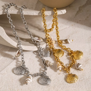 Macro view of 18k gold and silver ocean bracelets with starfish and natural sea shells