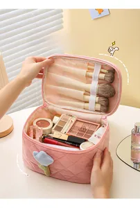 Pink quilted corduroy makeup bag with dedicated interior slots for cosmetic brushes
