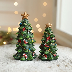 Mini green resin Christmas trees with colorful ornaments and gold stars on snow base