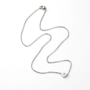 Close-up of heart pendant with I Love You engraving on silver stainless steel chain