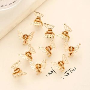 Close-up detail of golden butterfly mini hair claw clips set with 2.1cm size markings