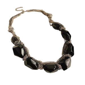 Chic irregular oval black pendant necklace with silver woven chain on white background