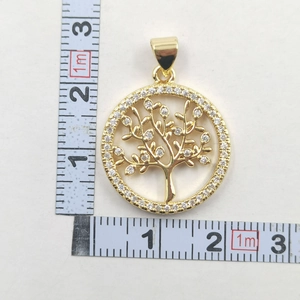 Detailed macro photo showing the 2cm diameter of the gold Tree of Life zircon pendant