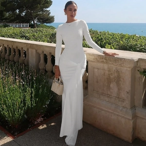 Detail showing the elegant waist knot and pleated design on this white long sleeve maxi dress
