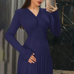 Detail of slim fit long sleeve dress with deep V-neck and ruched waist design