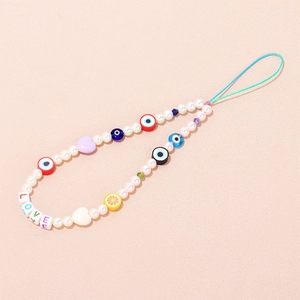 Detail of beaded phone lanyard with evil eyes, lemon slices, and colorful LOVE beads
