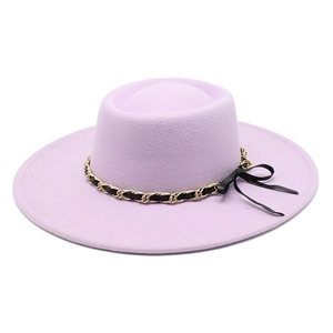 Detail of light purple wool fedora hat with gold chain and black bow decoration