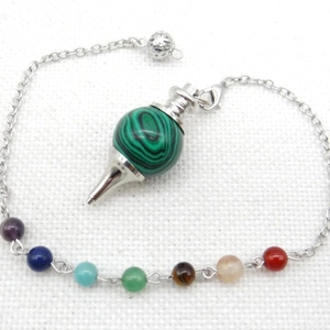 Detailed view of malachite pendulum with seven chakra beads on a silver chain necklace