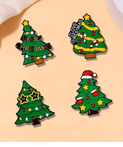 Detailed macro view of four vibrant enamel Christmas tree brooches with festive slogans