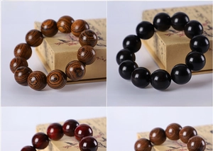 Detail view of four 20mm wooden bead bracelets in sandalwood and ebony textures