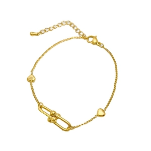Golden titanium steel bracelet with heart charms and horseshoe link on white background