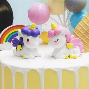 Cute resin unicorn cake toppers with gold horns and colorful manes for birthday decor