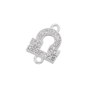 Macro detail of silver Libra zodiac charm with pavé zircon stones and double loops