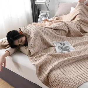 Light beige waffle weave cotton blanket with 3D texture for breathable summer bedding
