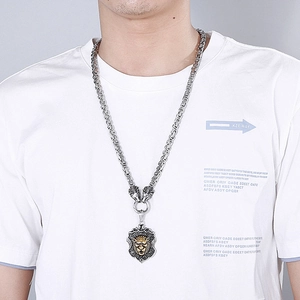 Men's titanium steel necklace with a gold lion head shield pendant on a silver chain