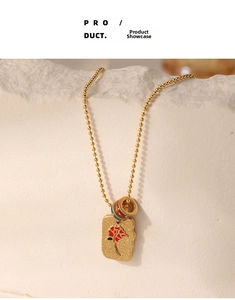 French vintage enamel flower necklace pendant on minimalist white stone background