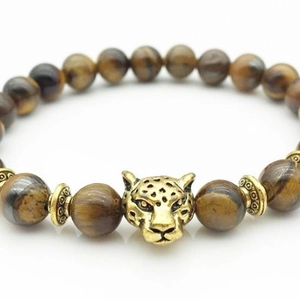 Tiger eye stone bracelet with golden leopard head and metallic spacer beads on white background