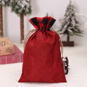 Christmas red burlap drawstring gift bag with buffalo plaid trim and rustic pine tree decor