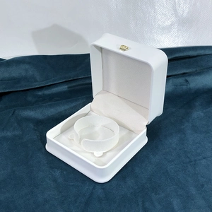 Detailed close-up of white PU leather jewelry box with curved bracelet holder insert