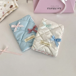 Detailed view of quilted cotton travel passport holders with cute bow accents and textures