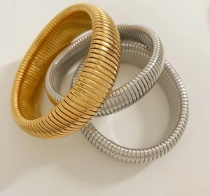 Detail of high-polished gold and silver Tubogas flexible snake bone stretch bracelets