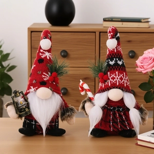 Standing Christmas gnomes pair with lantern and candy cane in a cozy indoor holiday setting