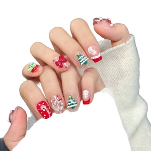 Christmas press-on nails with 3D reindeer, bows, and candy cane festive art designs