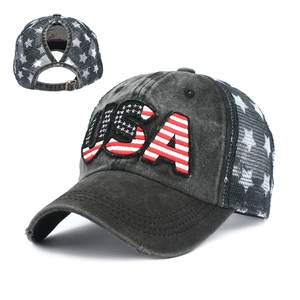 Detail of USA flag embroidery and ponytail hole on washed black mesh baseball cap