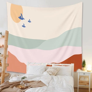 Detailed close-up of a bohemian abstract sun and mountain tapestry in a cozy bedroom setting