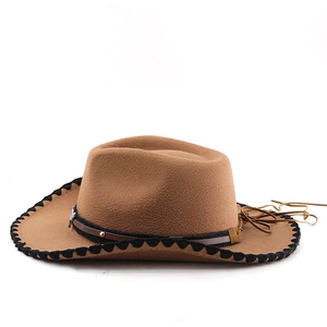Detail of western cowboy hat featuring leather band with gold studs and metal buckle