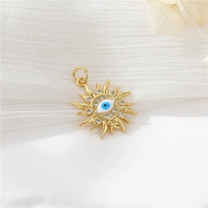 Macro view of gold sun pendant featuring devil eye design and sparkling cubic zirconia