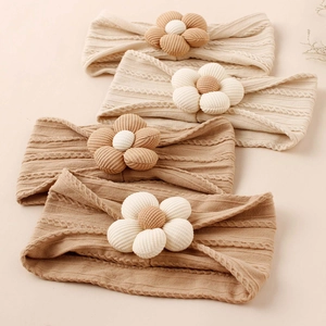 Set of four knitted nylon baby headbands with 3D floral accents in warm earthy tones