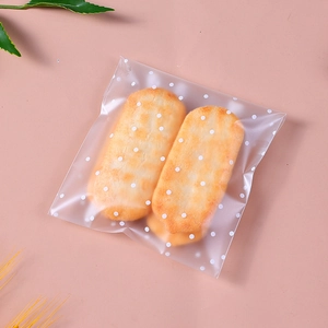 Frosted self-adhesive cookie bags with white polka dot pattern on pink background