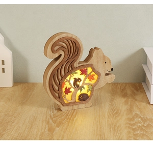 Macro shot of squirrel wood carving lamp with warm LED lighting and cut-out details