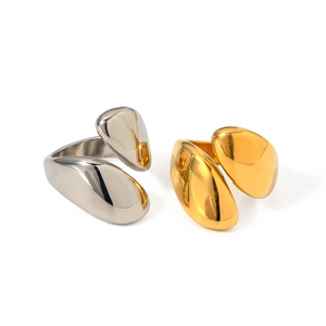 Polished stainless steel asymmetric open rings in gold and silver finishes on white background