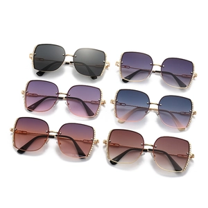 Detail showing six pairs of square metal sunglasses with rhinestone edges and gradient lenses